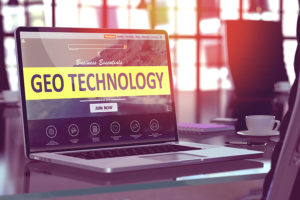 A laptop sitting on a glass desk in Southwest, FL with GEO technology written on the screen to indicate GEO fencing marketing services.